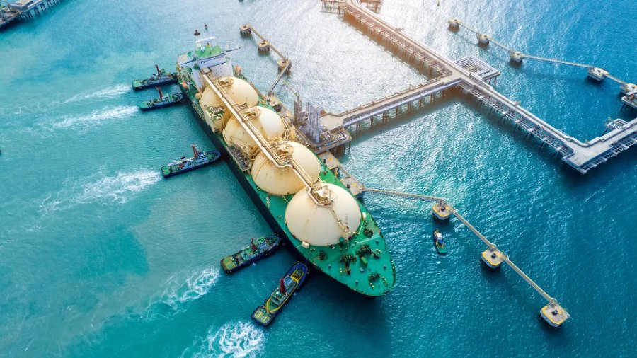 Navio metaneiro de GNL em operação de carregamento em terminal marítimo